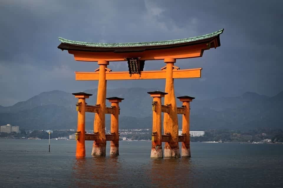 View of the floating torii gate of Itsukushima shrine on Miyajima island, captured against the background of dramatic clouds. The gate is a popular object of photography in Japan. 
