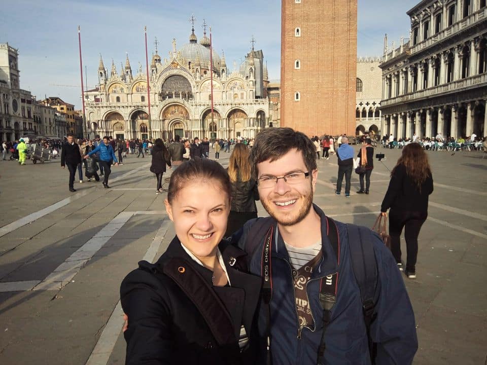 a couple's selfie on the san marco's square in venice with the basilica san marco in the background