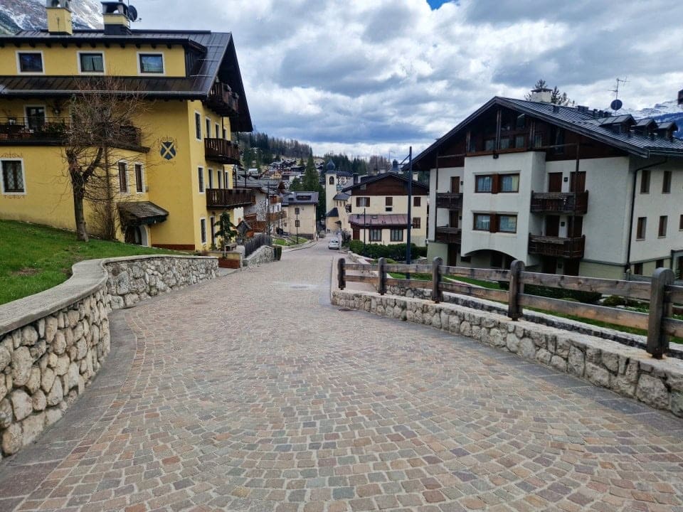 a cute little street with cute houses in cortina d'ampezzo dolomites italy